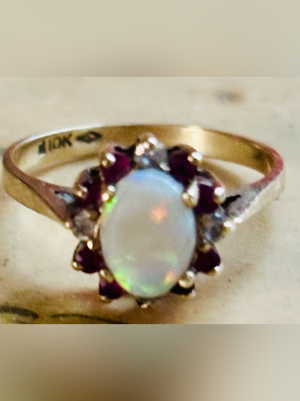 vintage 10K yellow gold oval opal, ruby, and diamond halo cluster ring
